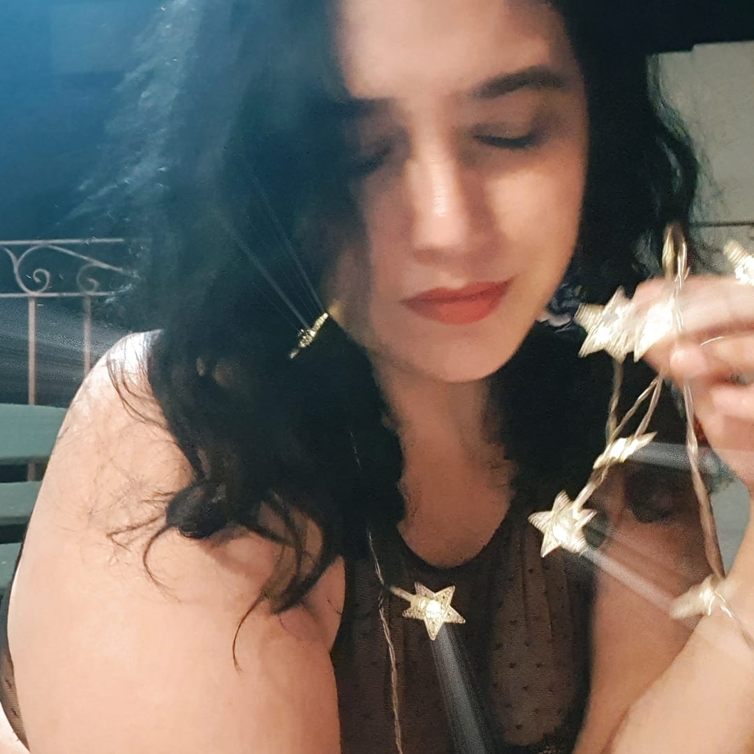 A pink flower with the words Somatic Feminism